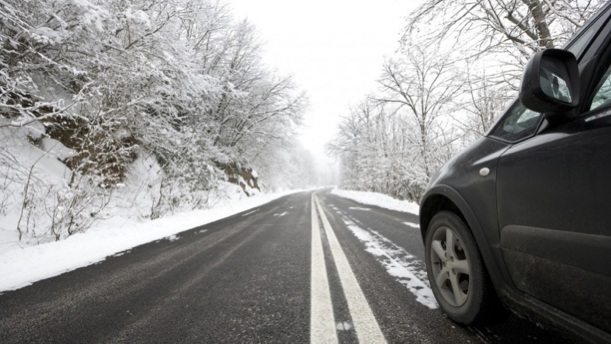 Car driving on a winter road with visible tread marks